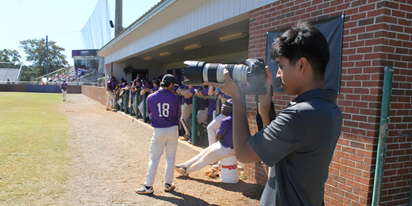 Student taking baseball photos